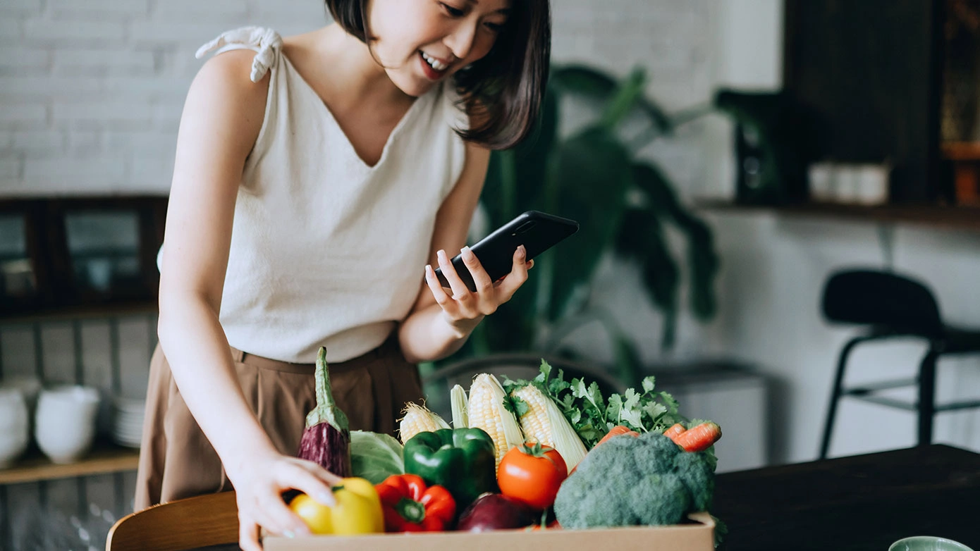 Shopper looking at a food order on her mobile device