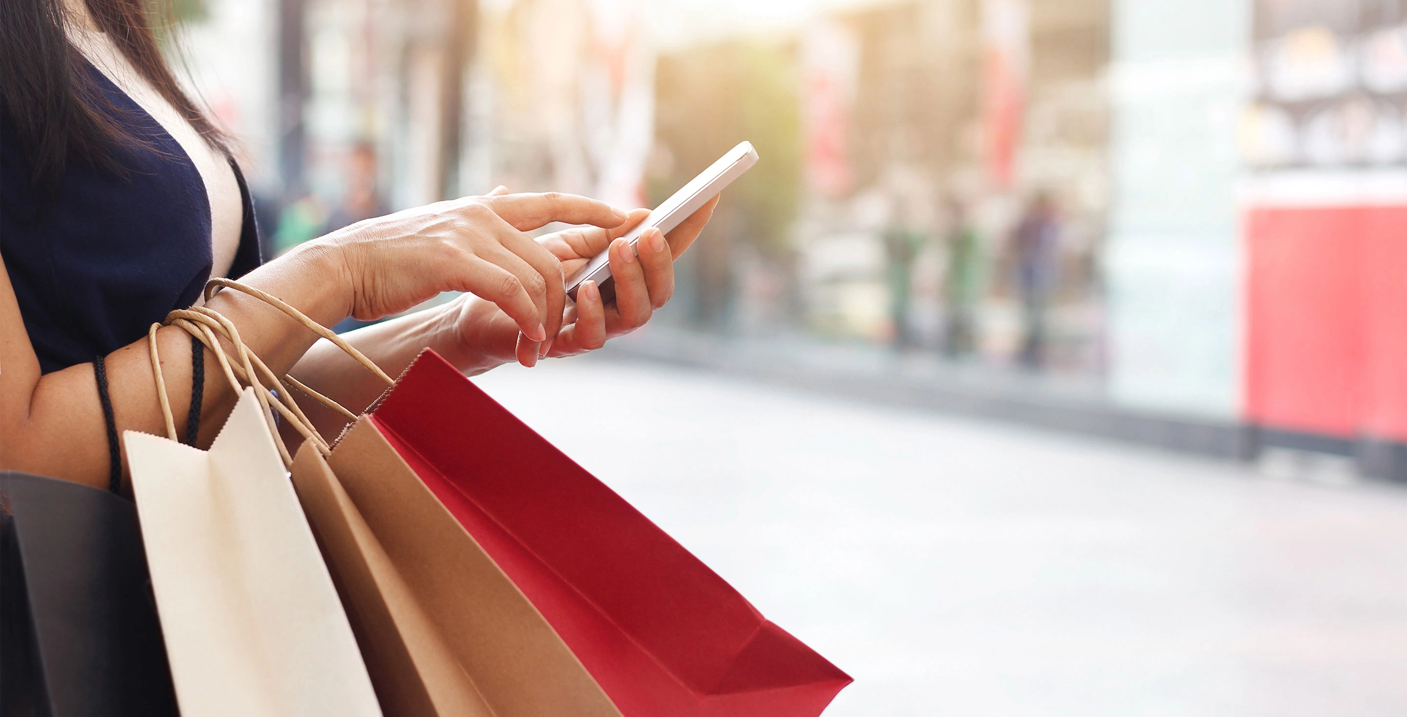 Shopper using mobile phone for a purchase